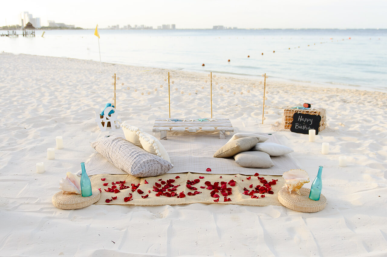 Cancun picnic white boho setup with rose petals